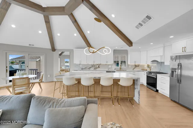 a large kitchen with a table and chairs