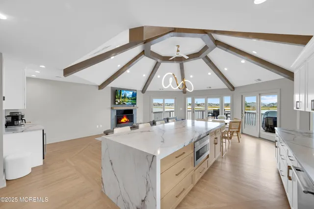 a large white kitchen with a large window