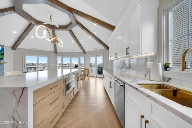 a kitchen with stainless steel appliances a refrigerator sink and stove