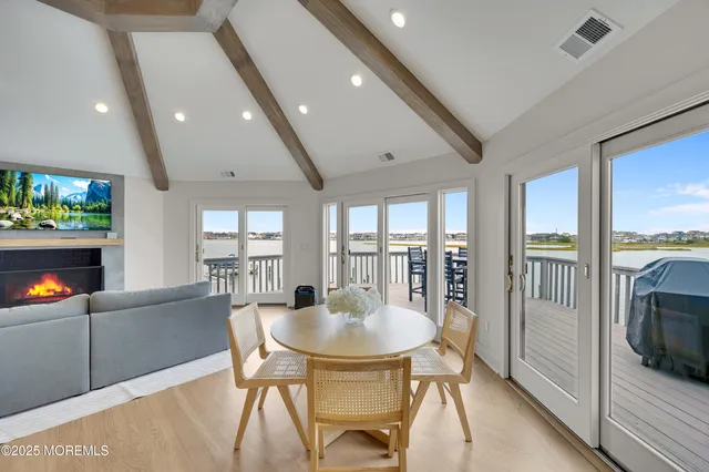 a dining room with stainless steel appliances kitchen island a table and chairs