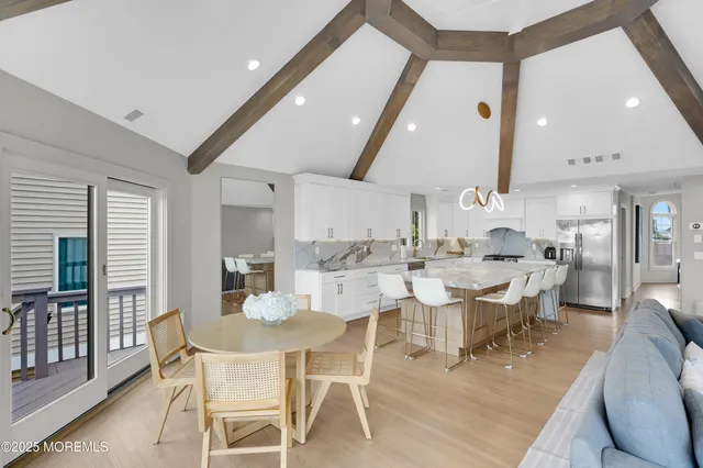 a large kitchen with kitchen island a dining table and chairs