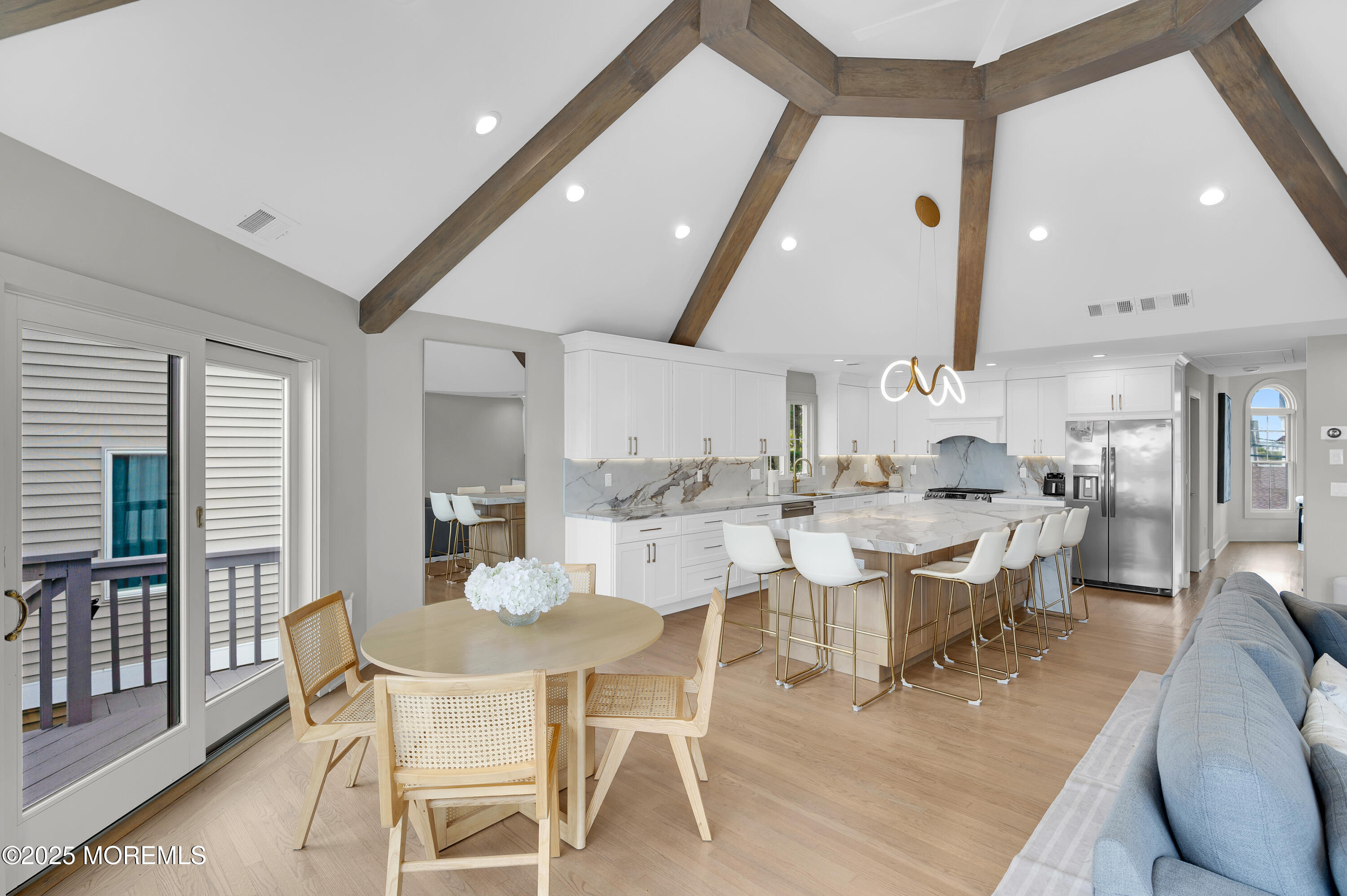 28 Harborside Drive East Seaside Heights, NJ 08751 - Photo 9 of 34 a dining room with stainless steel appliances kitchen island a table and chairs