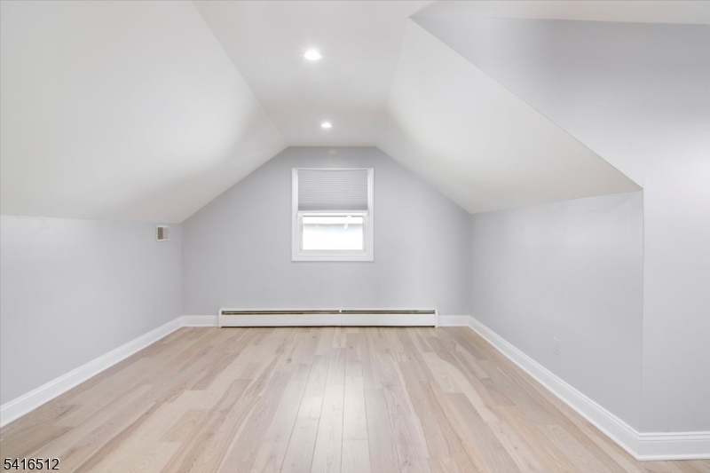 565 Center Street Wood-Ridge, NJ 07075 - Photo 14 of 26 an empty room with wooden floor and windows