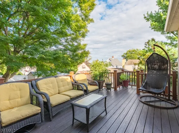a balcony with furniture and wooden floor
