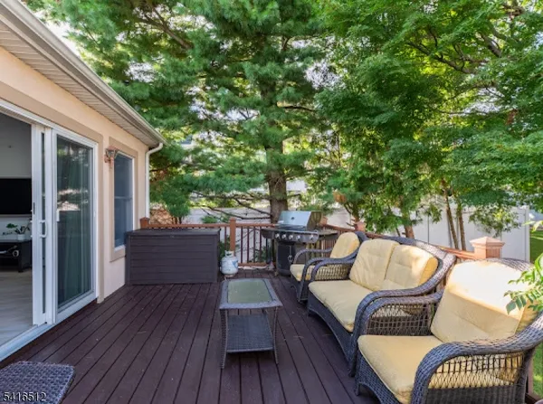 a patio with wooden floor and outdoor seating