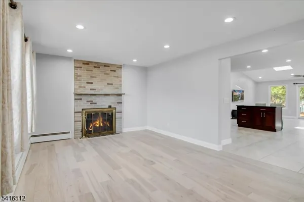 a view of an empty room with a fireplace