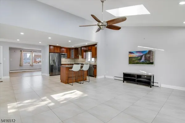 a living room with furniture and kitchen view