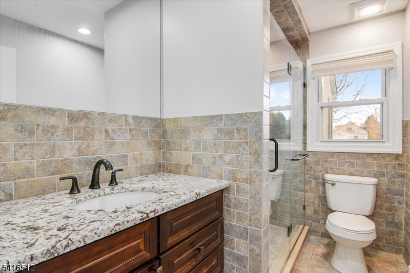 565 Center Street Wood-Ridge, NJ 07075 - Photo 7 of 26 a bathroom with a sink and a toilet
