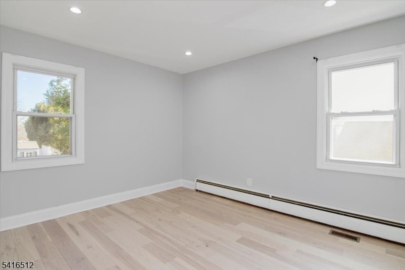 565 Center Street Wood-Ridge, NJ 07075 - Photo 8 of 26 wooden floor in an empty room with a window