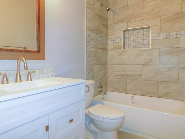 a bathroom with a sink a toilet and bathtub