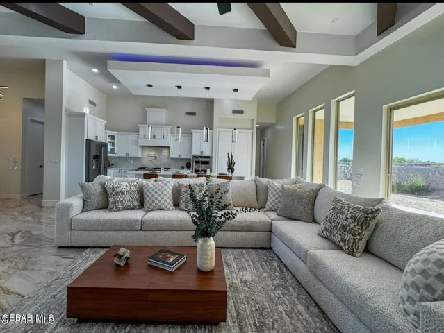 a living room with furniture and a chandelier