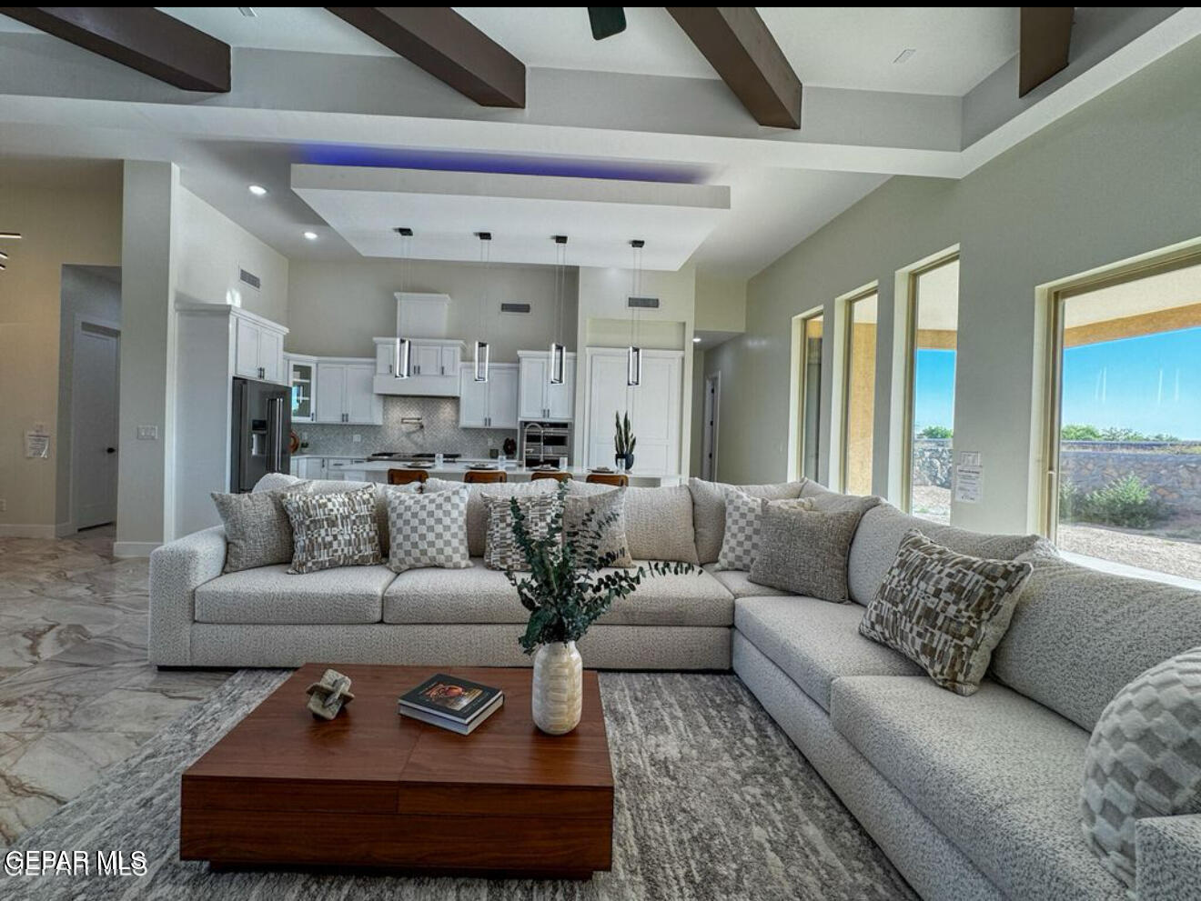 a living room with furniture and a chandelier