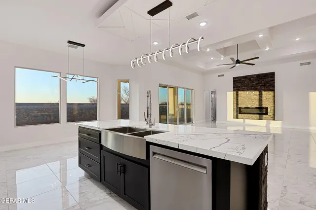 a kitchen with a sink a counter space and stainless steel appliances