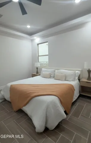 a bedroom with a bed and a night stand