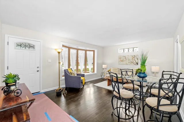a dining room with furniture and wooden floor