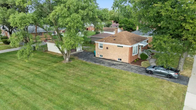 an aerial view of a house with a yard