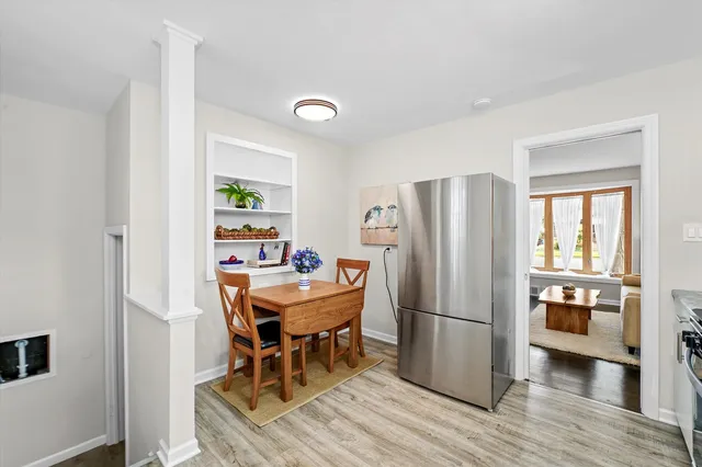 a dining room with furniture and wooden floor