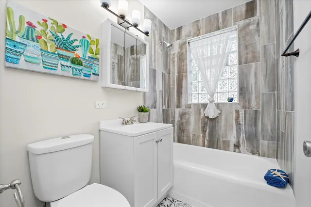 a bathroom with a sink a toilet and bathtub