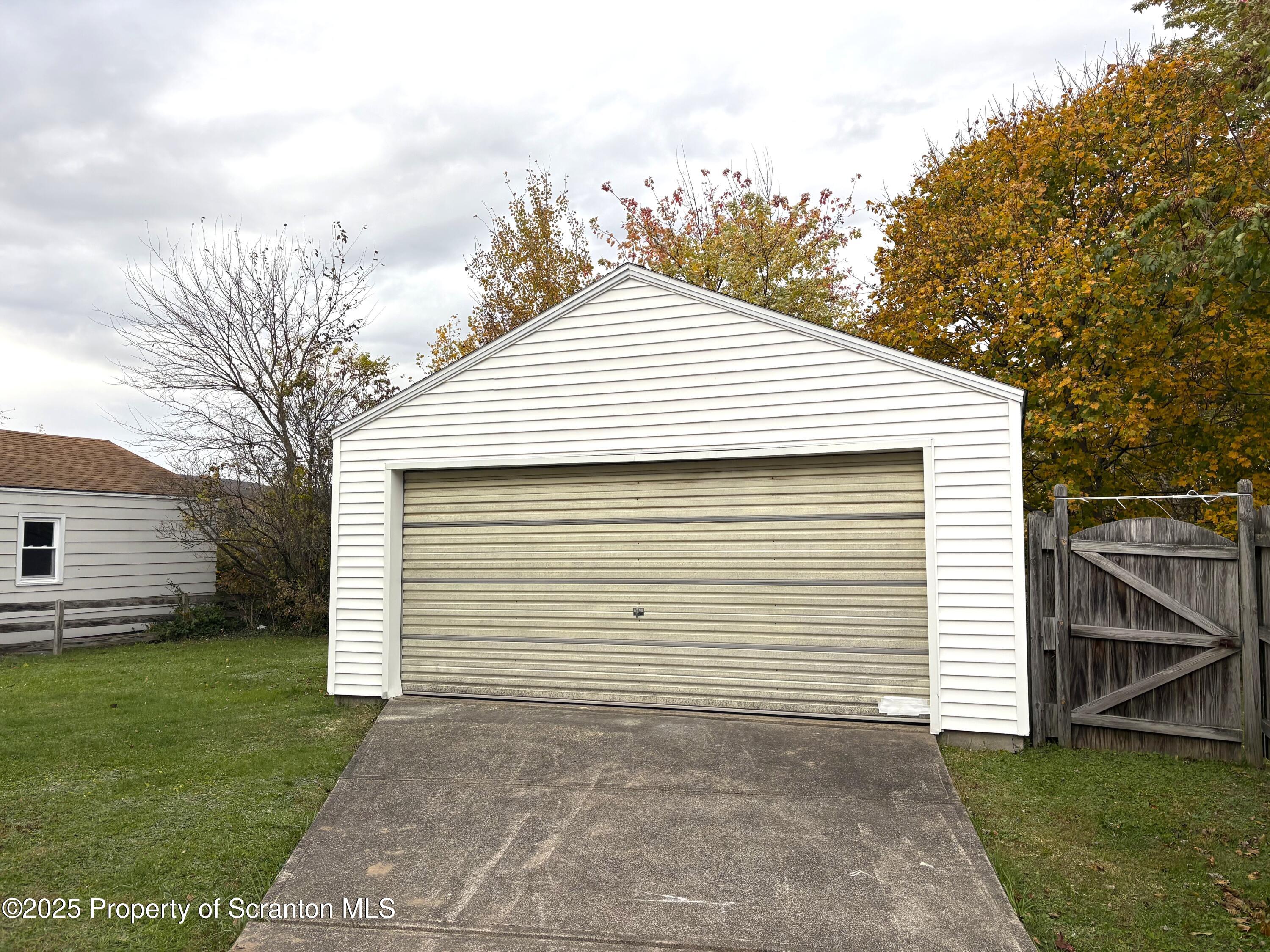 133 Corcoran Street Old Forge, PA 18518 - Photo 11 of 12 a view of a white house with a small yard and a large window