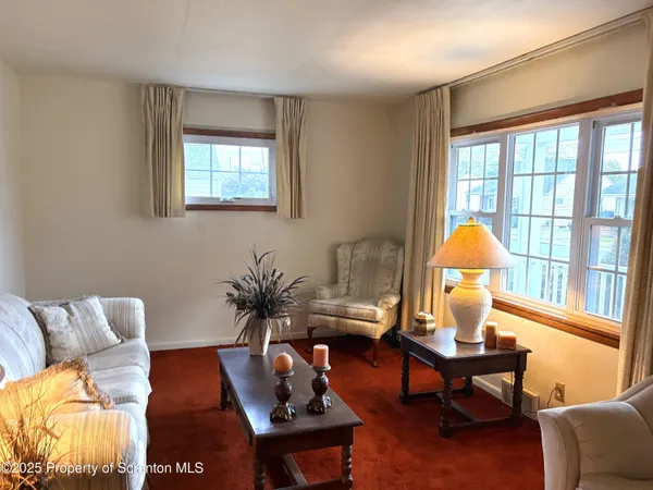 a living room with furniture and a lamp