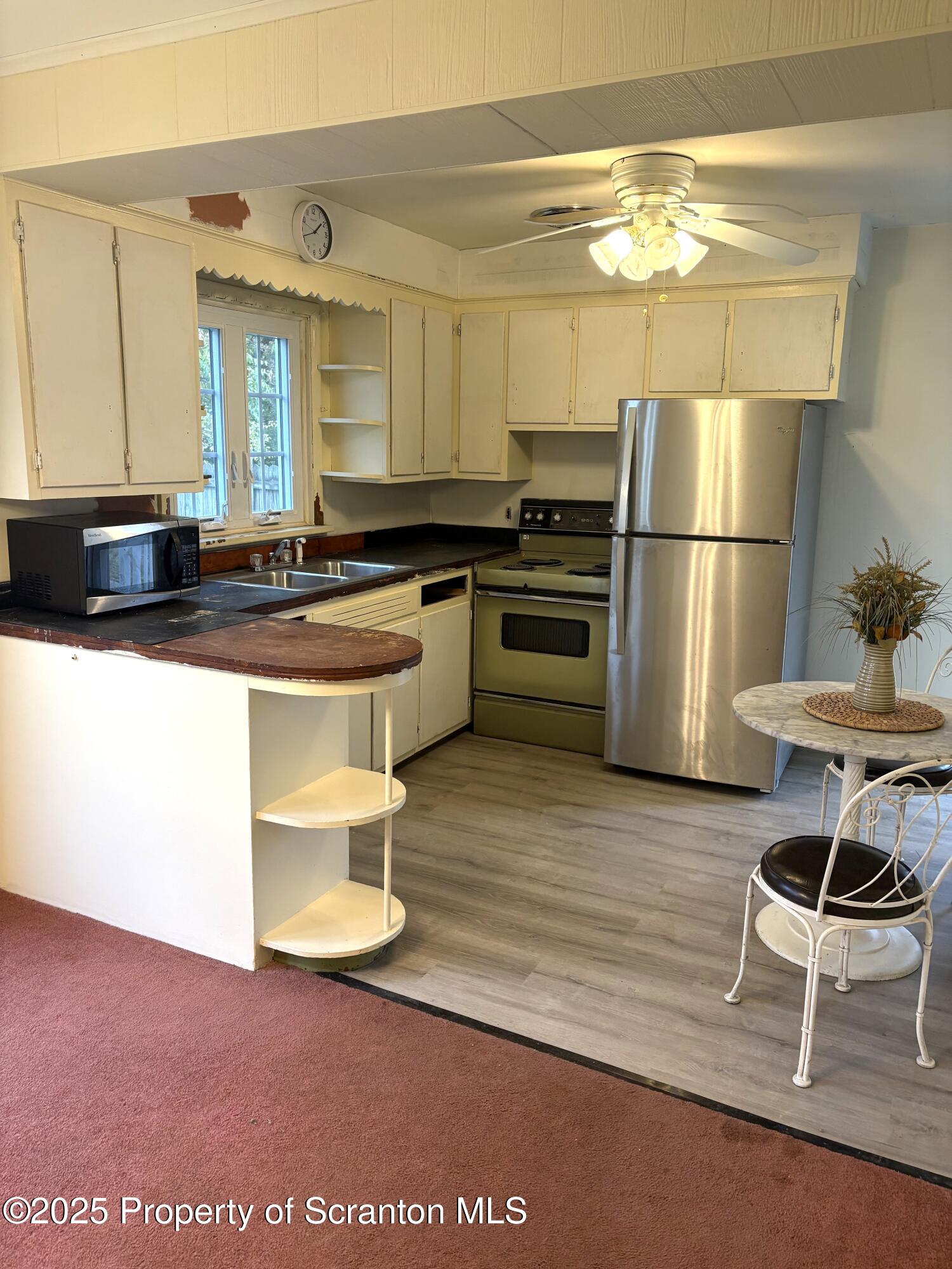 133 Corcoran Street Old Forge, PA 18518 - Photo 3 of 12 a kitchen with a sink and a stove top oven