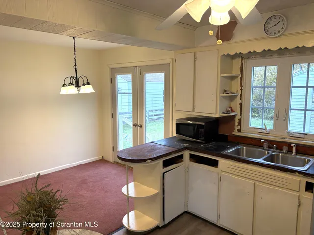 a kitchen with a sink appliances and cabinets