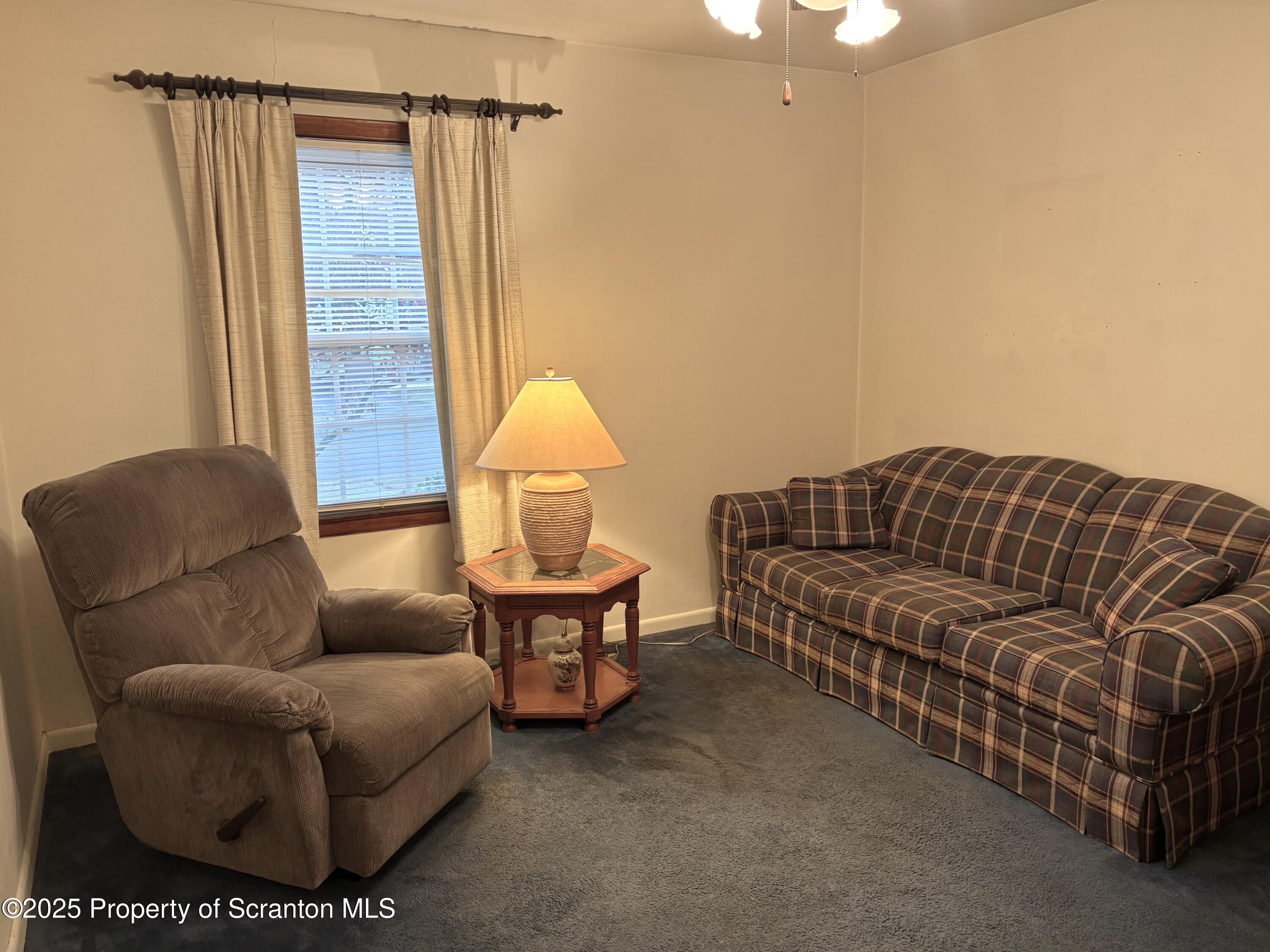 133 Corcoran Street Old Forge, PA 18518 - Photo 5 of 12 a living room with furniture and a window