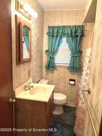 a bathroom with a sink toilet and mirror