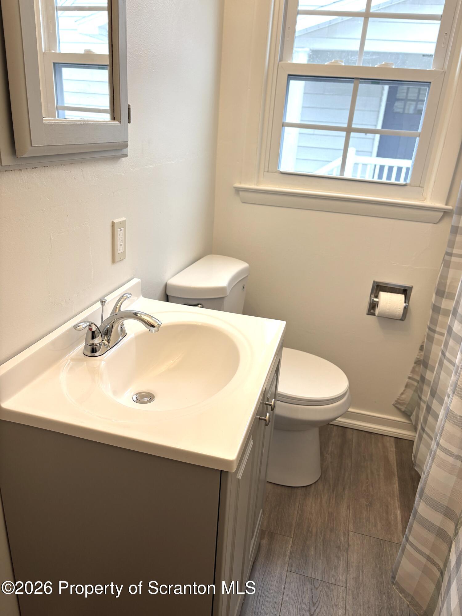 133 Corcoran Street Old Forge, PA 18518 - Photo 7 of 15 a bathroom with a sink toilet and mirror