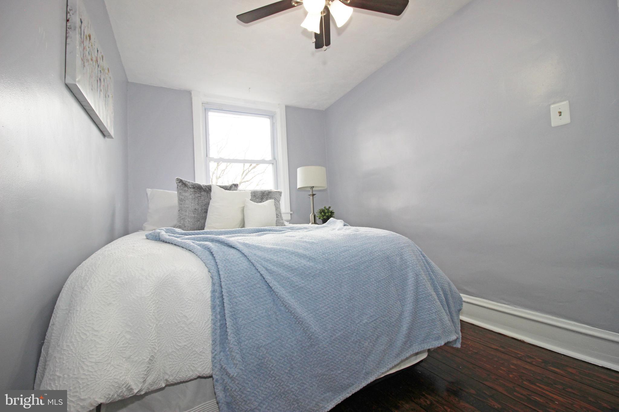 228 Guilford Road Lansdowne, PA 19050 - Photo 41 of 54 a bedroom with a bed and a chandelier