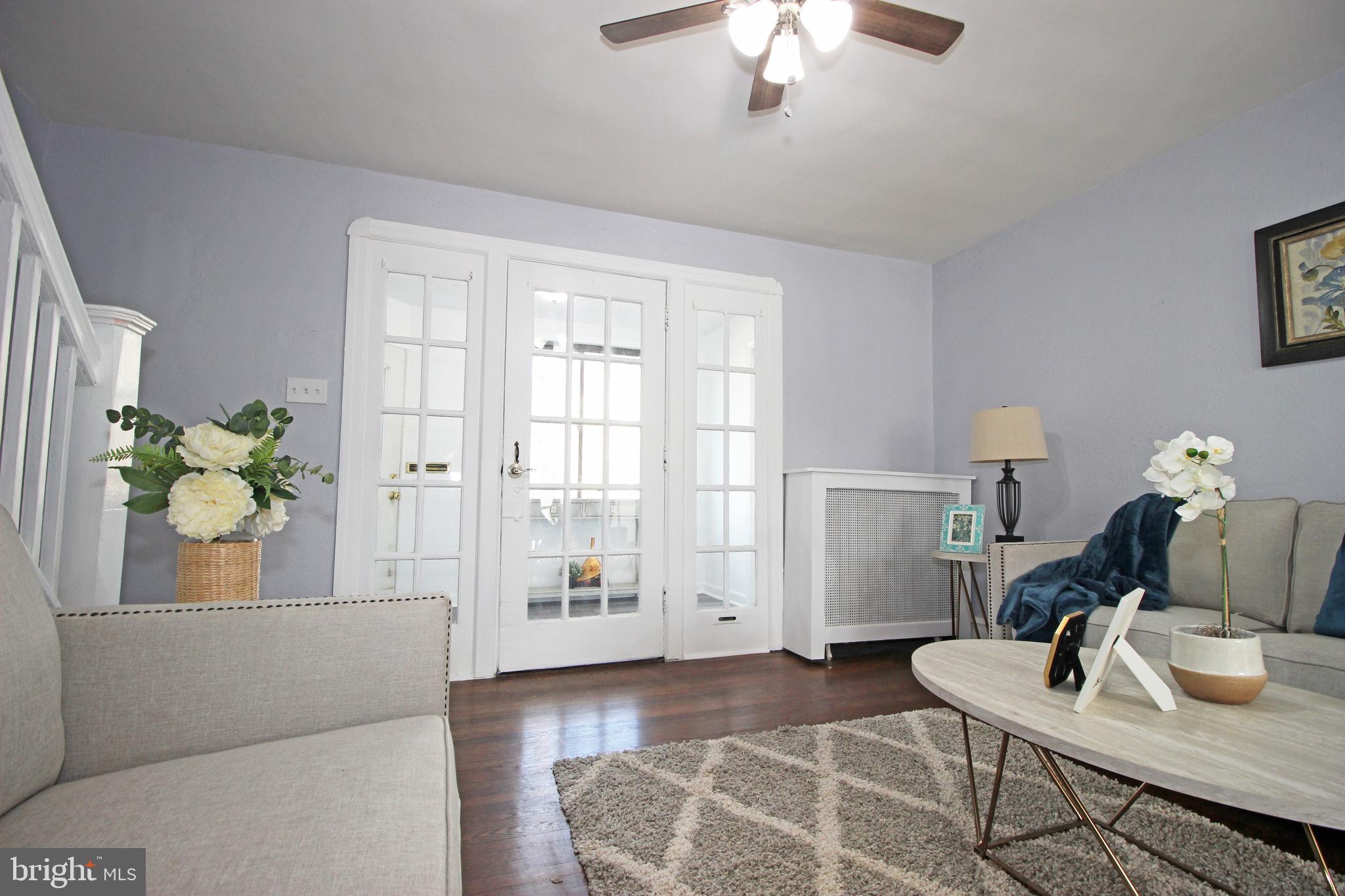 228 Guilford Road Lansdowne, PA 19050 - Photo 8 of 54 a living room with furniture and a chandelier