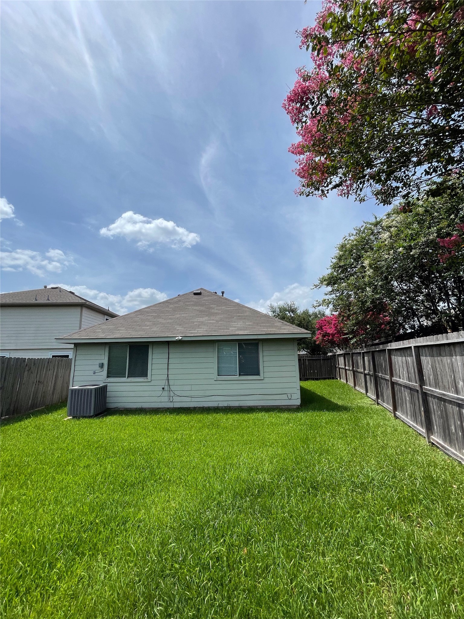 4010 Bealey Lane Houston, TX 77047 - Photo 22 of 29 Cozy backyard bordered by a wooden fence.