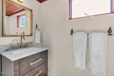a bathroom with a sink vanity and a mirror