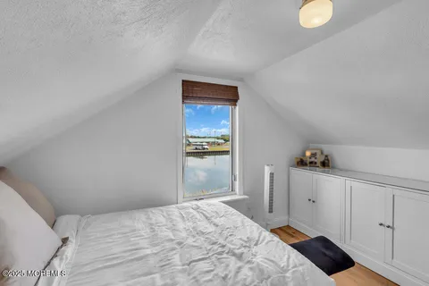 a bedroom with a bed and cabinet