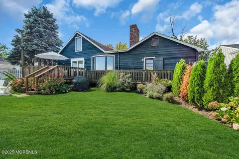 a view of a garden with lounge chairs