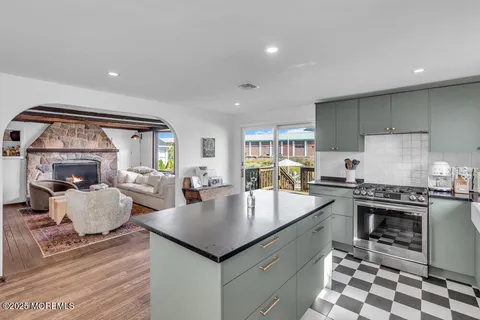 a large kitchen with sink a stove and cabinets