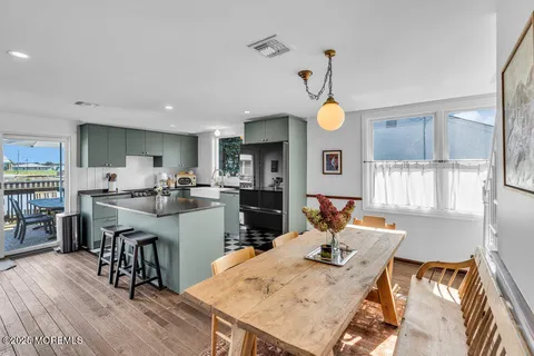 a living room with dining table and wooden floor