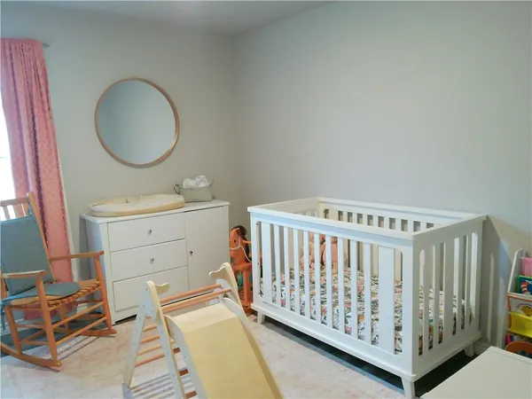 a view of a bedroom with furniture and windows