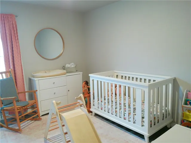a view of a bedroom with furniture and windows