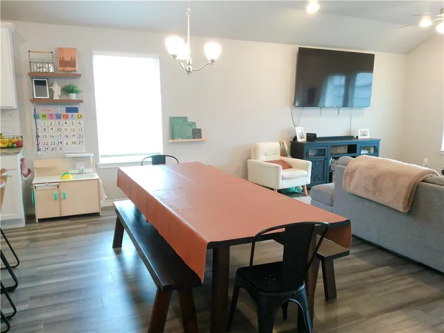a dining room with furniture and wooden floor