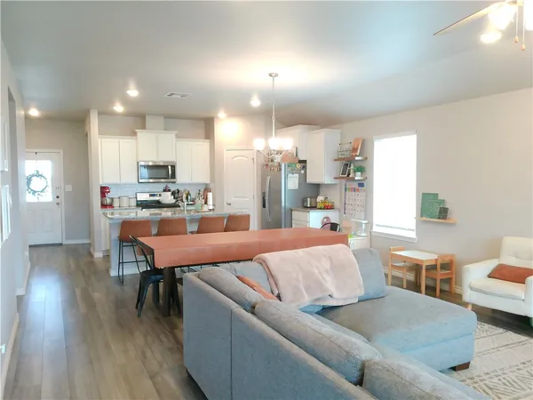 a living room with furniture and a wooden floor