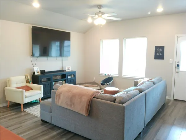 a living room with furniture and a flat screen tv