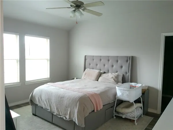 a bedroom with a bed and a chandelier