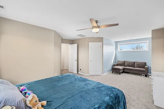 a bedroom with a bed and a couch