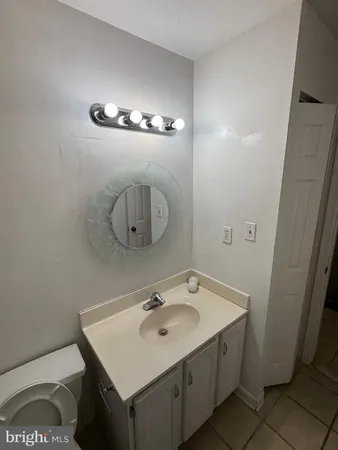 a bathroom with a sink a toilet and mirror