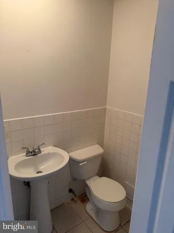 a bathroom with a sink toilet and a mirror
