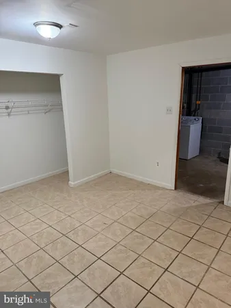 a view of an empty room and wooden floor