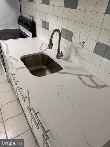 a close view of a sink a faucet and appliance in the kitchen