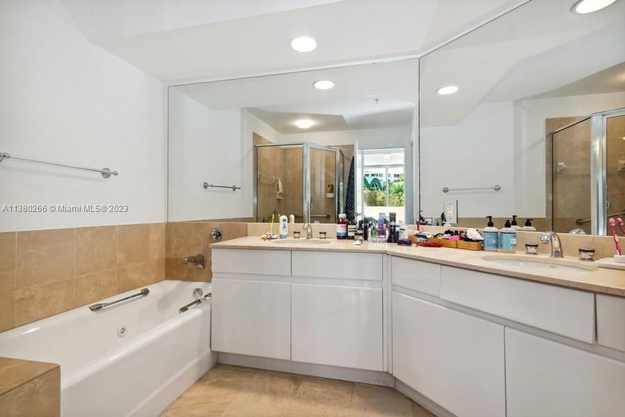 888 Brickell Key Drive, Unit 511 Miami, FL 33131 - Photo 11 of 26 a bathroom with a bathtub a double vanity sink and mirror