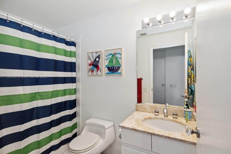 888 Brickell Key Drive, Unit 511 Miami, FL 33131 - Photo 13 of 26 a bathroom with a sink a toilet and a mirror